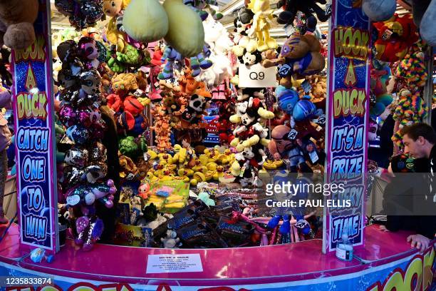 Plush toy rewards adorn a stall at the Hull Fair on October 11, 2021. - The Hull Fair, one of Europe's largest travelling fairs, returned after a...