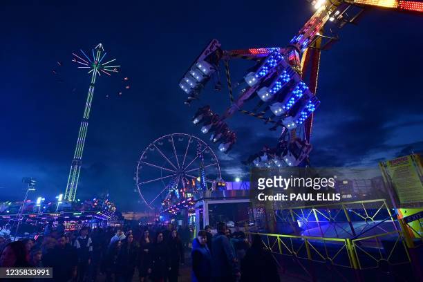 Visitors enjoy rides at the Hull Fair on October 11, 2021. - The Hull Fair, one of Europe's largest travelling fairs, returned after a break due to...