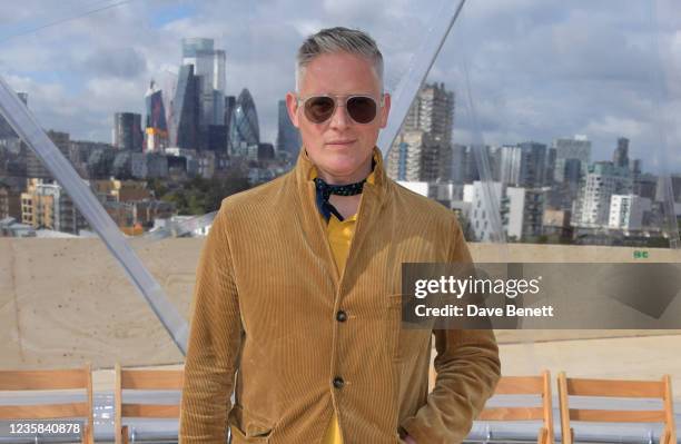 Giles Deacon attends the Alexander McQueen SS22 Womenswear show at Tobacco Dock on October 12, 2021 in London, England.