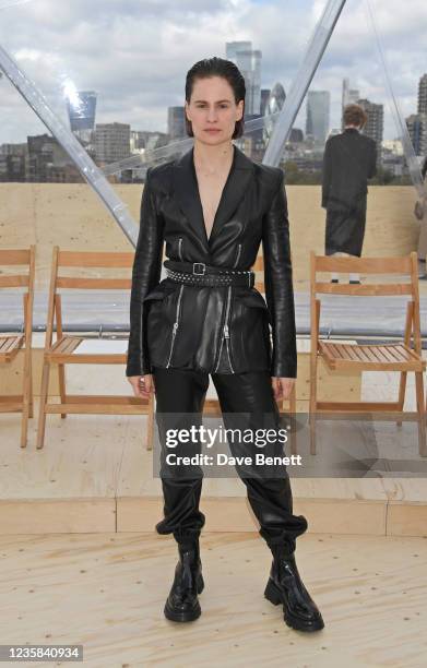 Christine and the Queens aka Heloise Letissier attends the Alexander McQueen SS22 Womenswear show at Tobacco Dock on October 12, 2021 in London,...