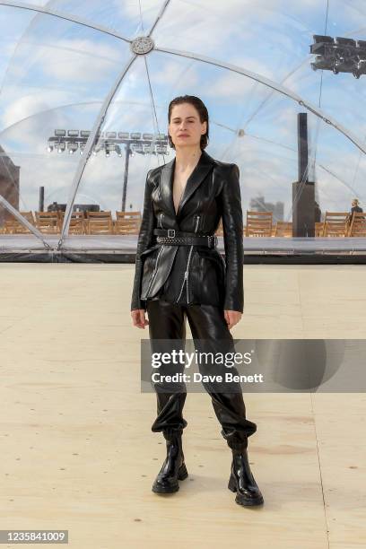 Christine and the Queens aka Heloise Letissier attends the Alexander McQueen SS22 Womenswear show at Tobacco Dock on October 12, 2021 in London,...