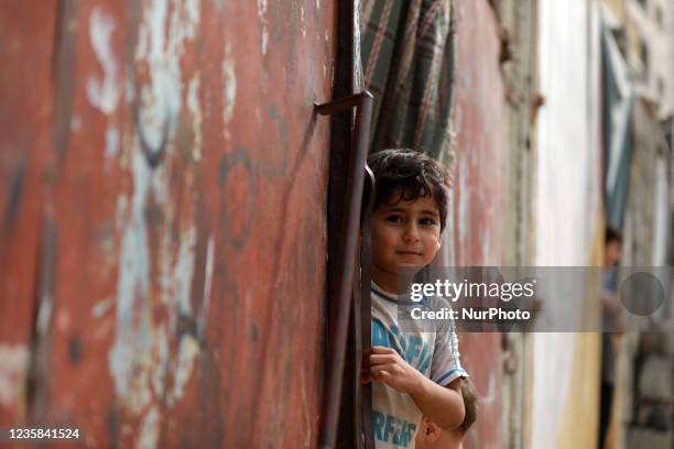 Palestinian children play next to their home in the Gaza Strip's al-Shati refugee camp in Gaza City on October 12, 2021.
