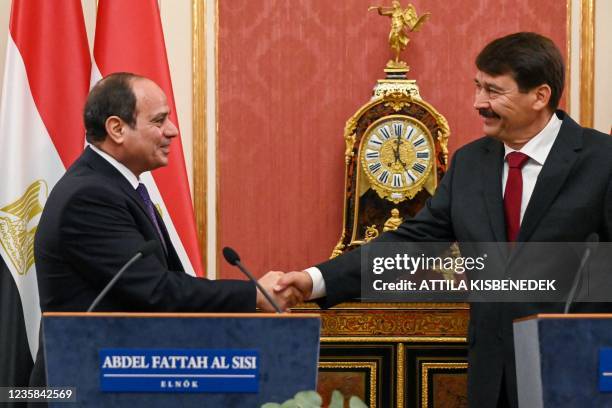 Hungary's President Janos Ader and Egyptian President Abdel Fattah al-Sisi shake hands at a joint press conference in the Maria Theresia hall of the...