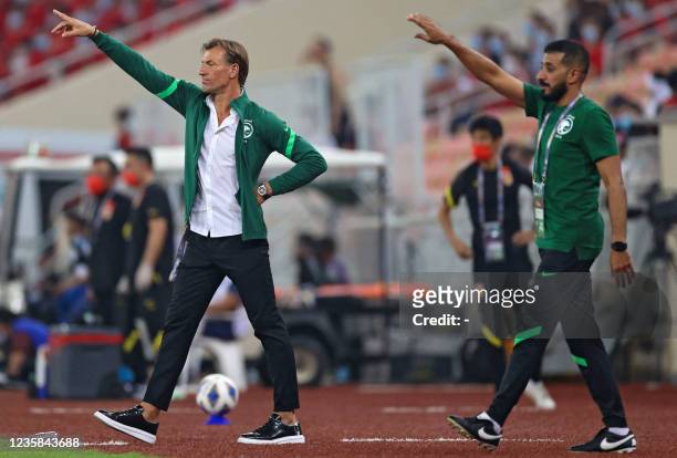 Saudi's coach Herve Renard speaks to his players during the 2022 Qatar World Cup Asian Qualifiers football match between Saudi Arabia and China, at...