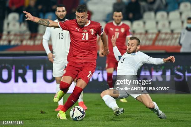 Serbia's midfielder Sergej Milinkovic-Savic fights for the ball with Azerbaijan's defender Maksim Medvedev during the FIFA World Cup 2022 Group A...