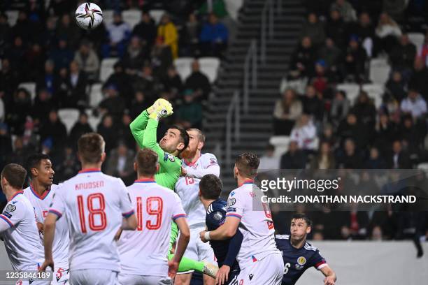 Faroes' goalkeeper Teitus Gestsson jumps to clear the ball during the FIFA World Cup Qatar 2022 qualification Group F football match between Faroe...