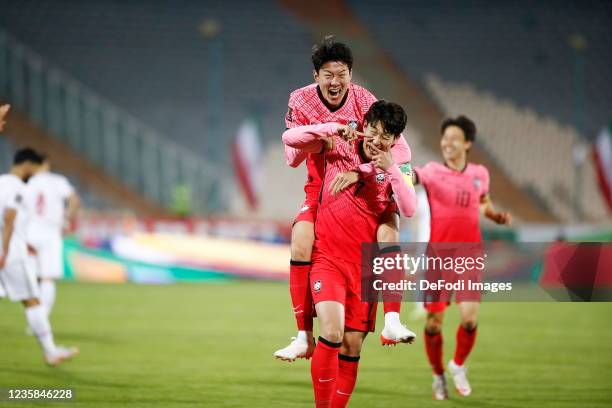 Son Heung Min of South Korea celebrates after scoring his team's first goal with Hwang Ui Jo during the 2022 FIFA World Cup Qualifier match between...