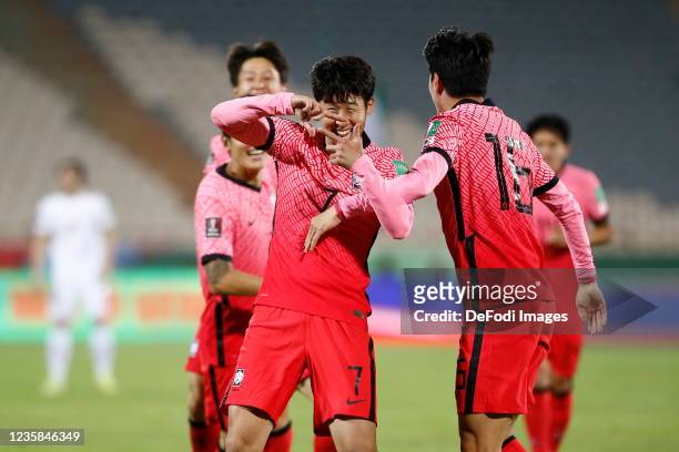 Son Heung Min of South Korea celebrates after scoring his team's first goal with teammates during the 2022 FIFA World Cup Qualifier match between...