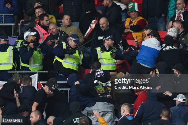 Police use their batons as they are attacked by Hungary fans during the 2022 FIFA World Cup Qualifier match between England and Hungary at Wembley...