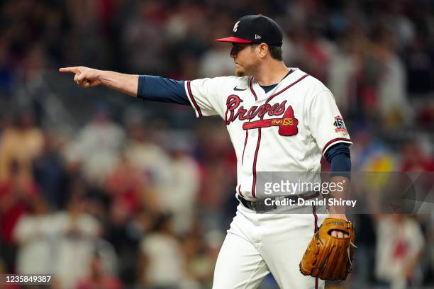 Luke Jackson of the Atlanta Braves reacts after throwing a pitch in the top of the seventh inning during Game 4 of the NLDS between the Milwaukee...