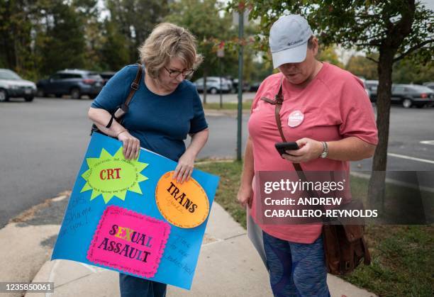 Protesters and activists stand outside a Loudoun County Public Schools board meeting in Ashburn, Virginia on October 12, 2021. - Loudoun county...