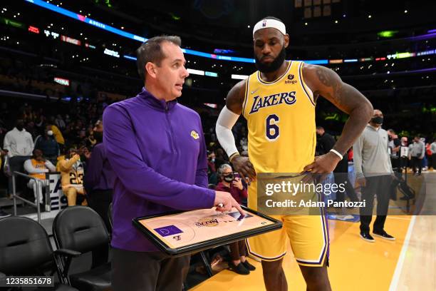 Head Coach Frank Vogel of the Los Angeles Lakers talks to LeBron James during a preseason game against the Golden State Warriorson October 12, 2021...