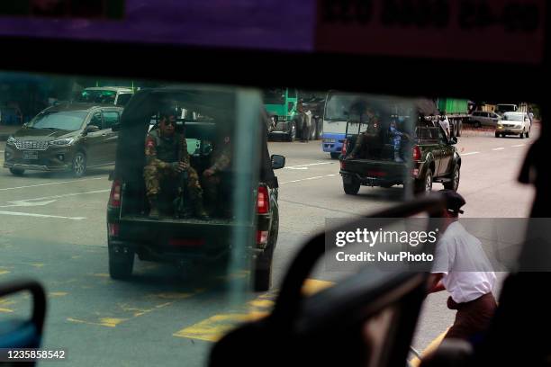 Armed soldiers in a military vehicle patrol the street in Yangon, Myanmar on October 13, 2021.