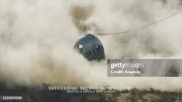 Screenshot taken from a live handout video on October 13, 2021 shows Blue Origin's New Shepard crew capsule lands in Texas, the United States....