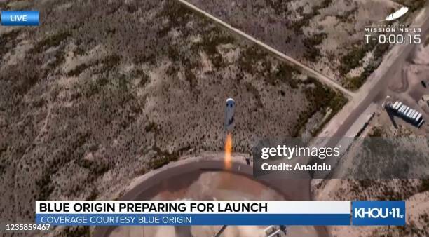 Screenshot taken from a live handout video on October 13, 2021 shows Blue Origin spacecraft New Shepard takes-off in Texas, the United States....