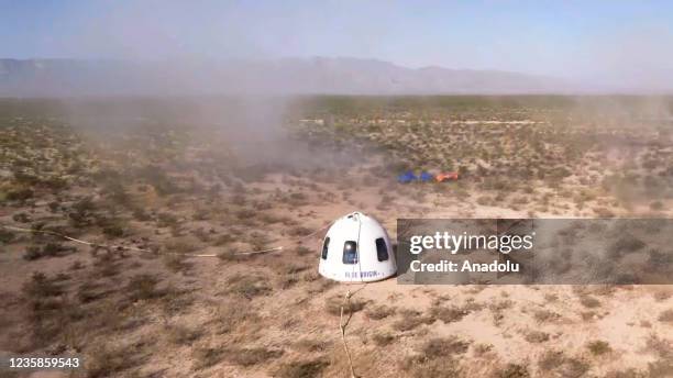 Screenshot taken from a live handout video on October 13, 2021 shows Blue Origin's New Shepard crew capsule lands in Texas, the United States....