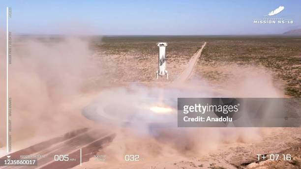 Screenshot taken from a live handout video on October 13, 2021 shows Blue Origin spacecraft New Shepard returns in Texas, the United States. William...