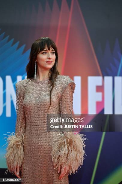 American actress Dakota Johnson poses on the red carpet on her arrival to attend the European premiere of the film 'The Lost Daughter', during the...
