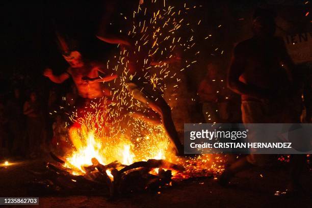 People take part in the "Baile de la Candela" religious ceremony on the Sorte mountain, in Yaracuy state, Venezuela, on October 12, 2021. - On...