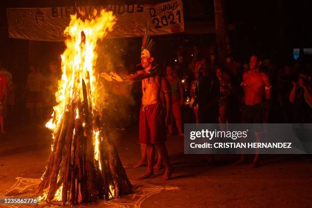 Victor Medina put his hands near a bonfire before taking part in the "Baile de la Candela" religious ceremony on the Sorte mountain, in Yaracuy...