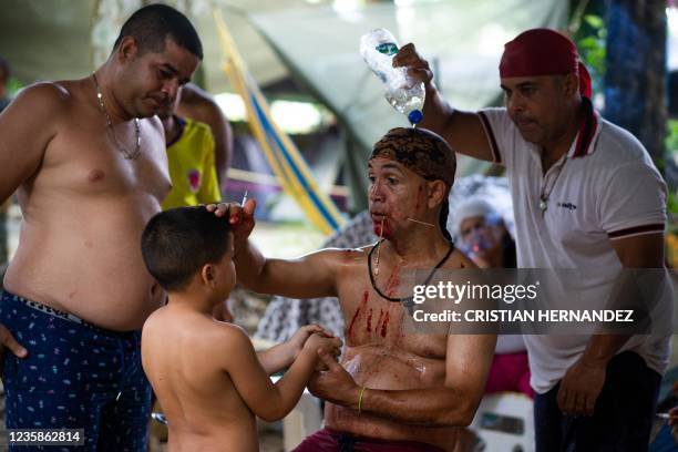 Tilo Pereira performs a ritual to channel ancient spirits with a boy on the Sorte mountain in Yaracuy state, Venezuela, on October 11, 2021. - On...