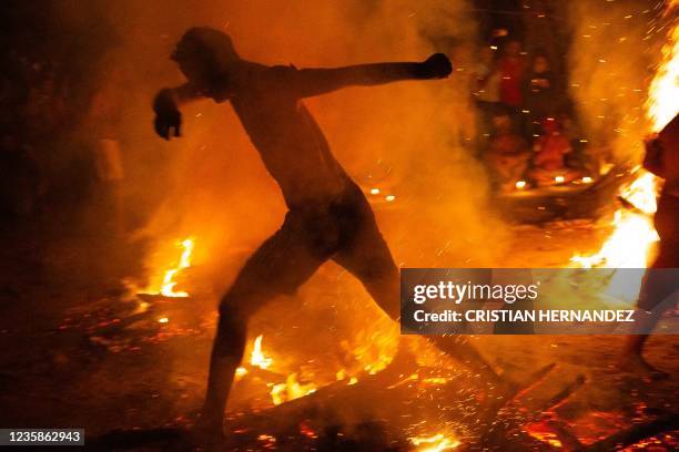 People take part in the "Baile de la Candela" religious ceremony on the Sorte mountain, in Yaracuy state, Venezuela, on October 12, 2021. - On...