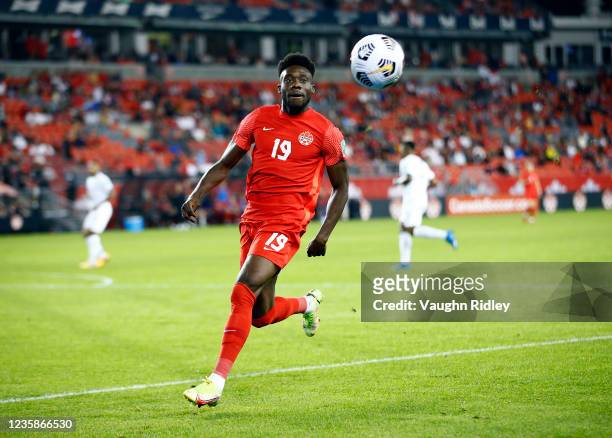 Alphonso Davies of Canada chases the ball during a 2022 World Cup Qualifying match against Panama at BMO Field on October 13, 2021 in Toronto,...