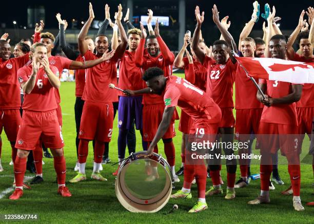 Alphonso Davies of Canada bangs a supporters drum following the final whistle of a 2022 World Cup Qualifying match against Panama at BMO Field on...