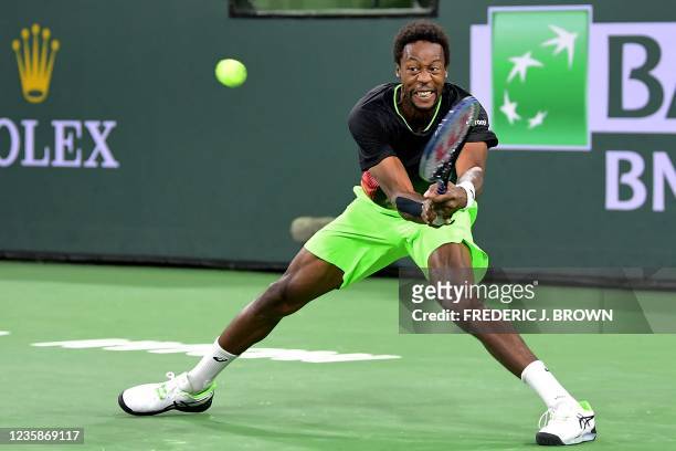 Gael Monfils of France hits a backhand return to Alexander Zverev of Germany during their Round of 16 match at the ATP-WTA Indian Wells tennis...