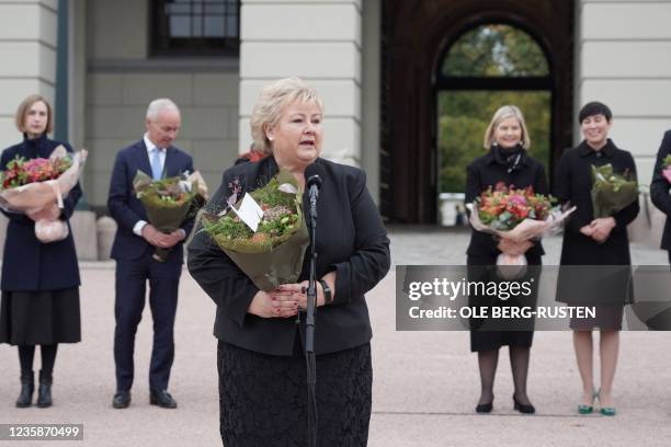 Norway's outgoing Prime Minister Erna Solberg stands in front of ministers of her cabinet Iselin Nybo, Jan Tore Sanner, Guri Melby and Ine Eriksen...