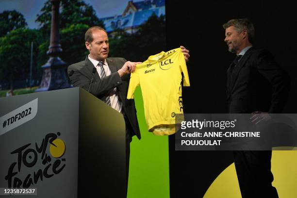 Prince Frederik of Denmark receives a yellow jersey from Tour de France director Christian Prudhomme during the official presentation of the 2022...