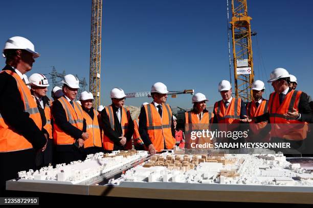 French President Emmanuel Macron, French Prime Minister Jean Castex and Paris Mayor Anne Hidalgo listen to Olympic Delivery Authority Solideo's Chief...