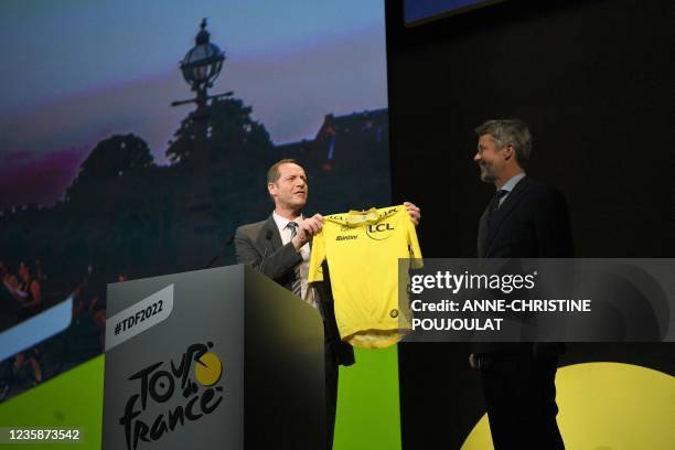 Prince Frederik of Denmark receives a yellow jersey from Tour de France director Christian Prudhomme during the official presentation of the 2022...