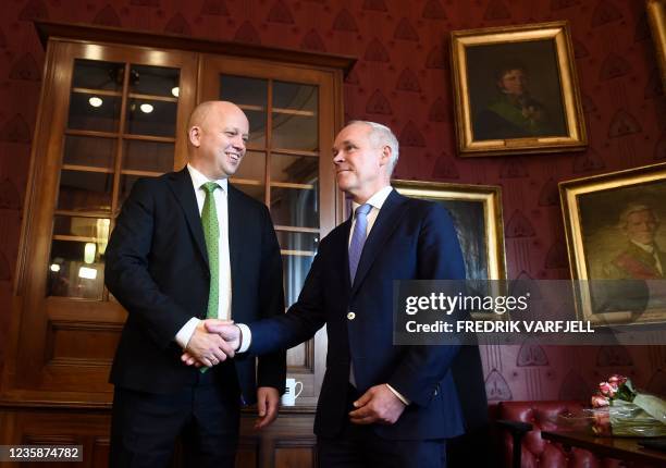 Norway's outgoing Minister of Finance Jan Tore Sanner and incoming Minister of Finance Trygve Slagsvold Vedum shake hands during the key handover...