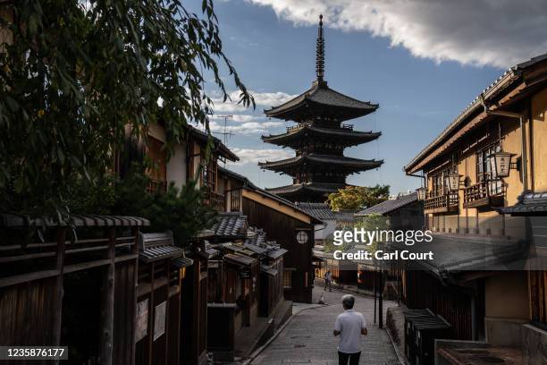 People pass next to Hokan-ji Temple on October 14, 2021 in Kyoto, Japan. Amid an almost complete drop in foreign tourism revenue and issues including...