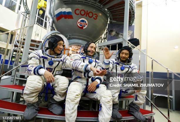 Russian cosmonaut Alexander Misurkin and space flight participants - Japanese billionaire Yusaku Maezawa and his assistant Yozo Hirano - attend a...