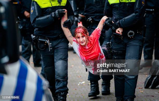 Climate activist of Extinction Rebellion is carried by policemen at the party office of the CDA, as she participates in a protest on the fourth day...