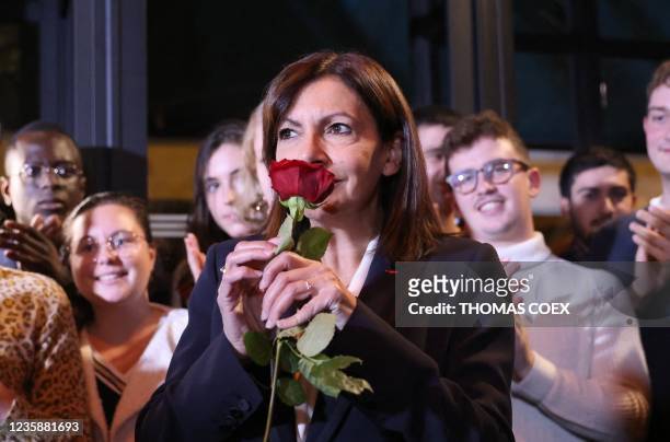 Paris Mayor and Socialist Party candidate for the 2022 French presidential election Anne Hidalgo smells a rose during the result of the vote of the...