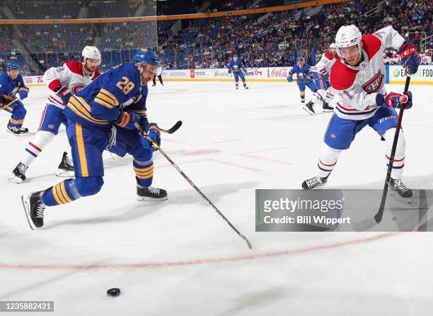 Zemgus Girgensons of the Buffalo Sabres battles against Jake Evans of the Montreal Canadiens during an NHL game on October 14, 2021 at KeyBank Center...