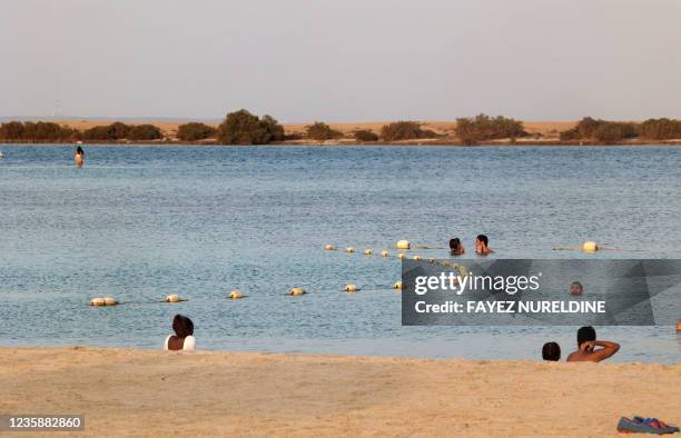 Beachgoers swim at Pure Beach in King Abdullah Economic City -- about 125 kilometres south of Jeddah's city centre, on the Red Sea, on September 17,...