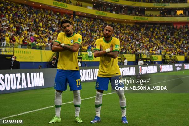 Brazil's Neymar celebrates with Brazil's Lucas Paqueta after scoring against Uruguay during the South American qualification football match for the...
