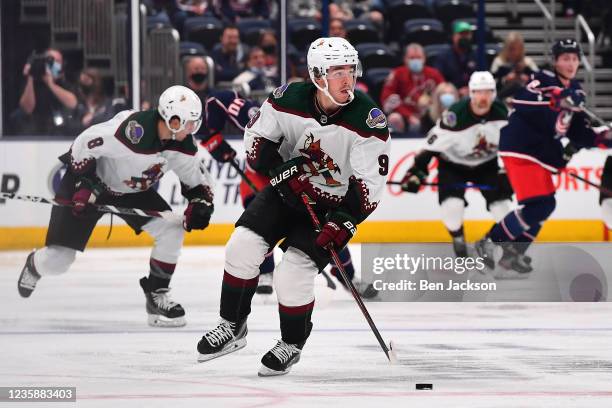 Clayton Keller of the Arizona Coyotes controls the puck against the Columbus Blue Jackets in the second period at Nationwide Arena on October 14,...