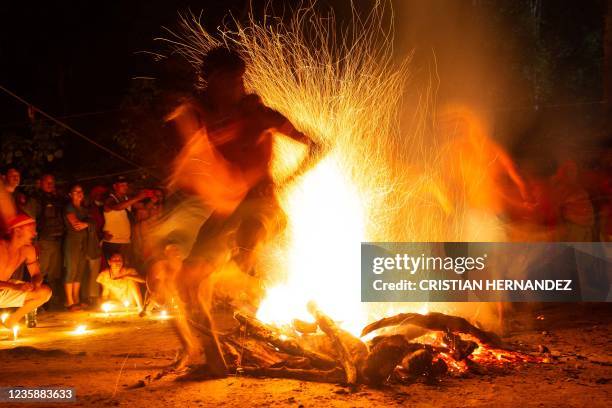 Graphic content / TOPSHOT - People take part in the "Baile de la Candela" religious ceremony on the Sorte mountain, in Yaracuy state, Venezuela, on...