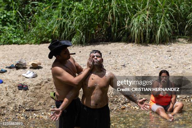 Men take a spiritual bath in the Yaracuy River on the Sorte mountain in Yaracuy state, Venezuela, on October 11, 2021. - On October, thousands of...
