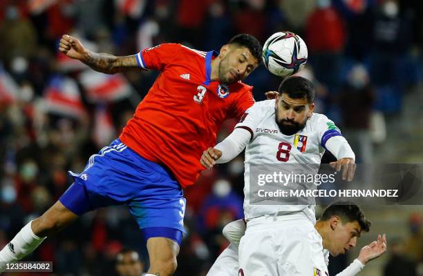 Chile's Guillermo Maripan and Venezuela's Tomas Rincon vie for the ball during their South American qualification football match for the FIFA World...