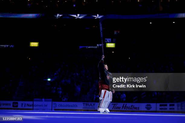 Elvis Merzlikins of the Columbus Blue Jackets waves to the crowd after being named the second star of the game after defeating the Arizona Coyotes...