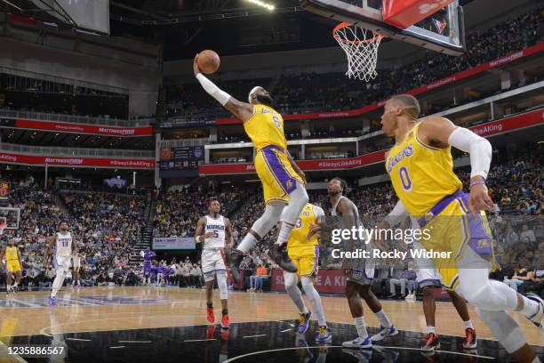 LeBron James of the Los Angeles Lakers dunks the ball during a preseason game against the Sacramento Kings on October 14, 2021 at Golden 1 Center in...