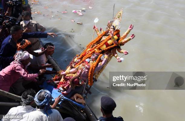 Devotees immerse an idol of Goddess Durga on the final day of Durga Puja festival in Guwahati, India on Oct. 15, 2021.