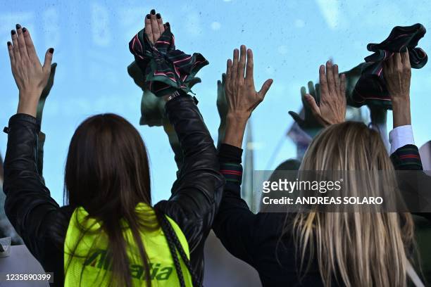 Employees of Italian airline Alitalia take part in a protest outside Terminal 1 of Rome's Fiumicino airport on October 15 as new Italian airline...