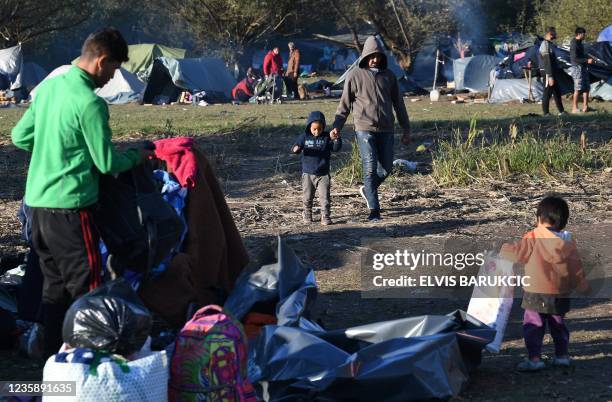 Afghan people are seen at an illegal improvised camp, outside Northern-Bosnian border town of Velika Kladusa, on October 15, 2021. - Some 300 illegal...